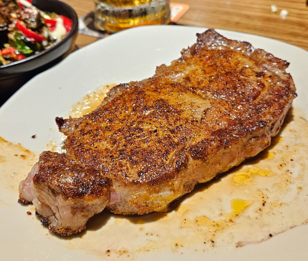 Juicy ribeye steak on a plate.
