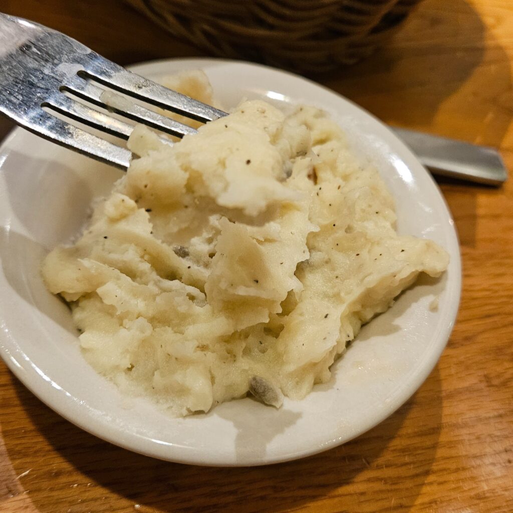 Mashed potato on a plate with fork.