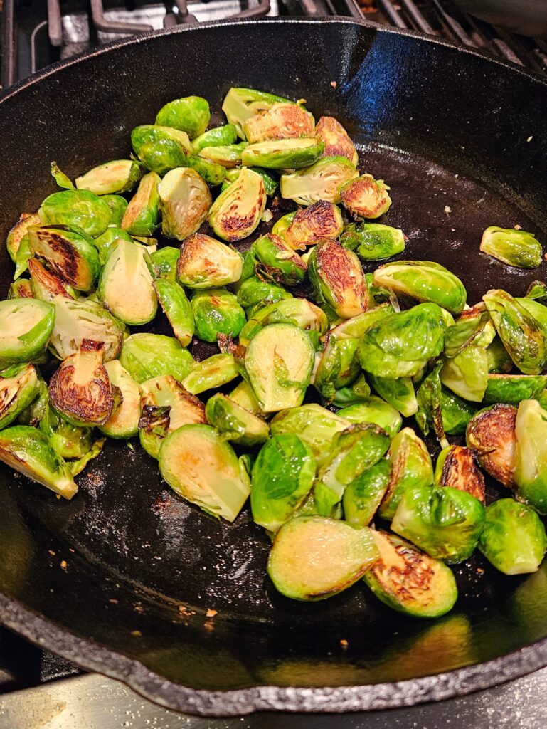 Charred Brussels sprouts on a pan.