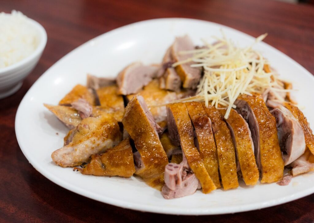 Roasted goose meat on a plate.